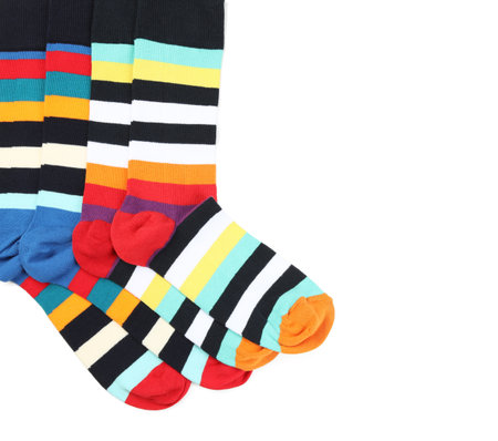 Colorful socks on white background, top view