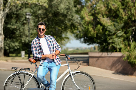 Handsome young hipster man with bicycle outdoorsの写真素材