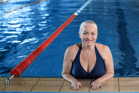 Sportive senior woman in indoor swimming pool