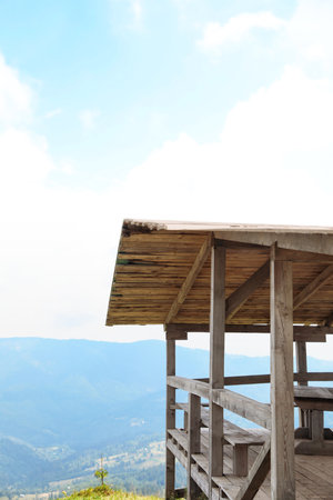 Picturesque landscape with wooden gazebo and mountain forest on backgroundの写真素材