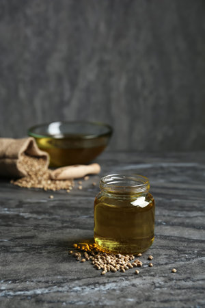 Jar with hemp oil on gray tableの写真素材