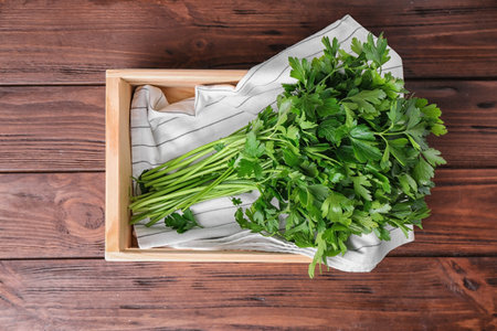 Crate with fresh green parsley on wooden background, top viewの写真素材