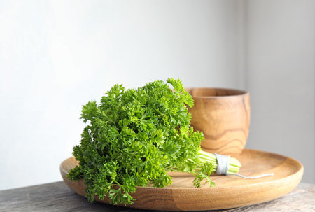 Dishware and fresh green parsley on tableの写真素材