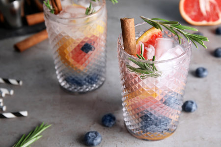 Tasty refreshing grapefruit cocktail with rosemary on tableの写真素材