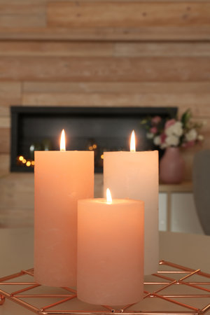 Burning candles on table in living roomの写真素材