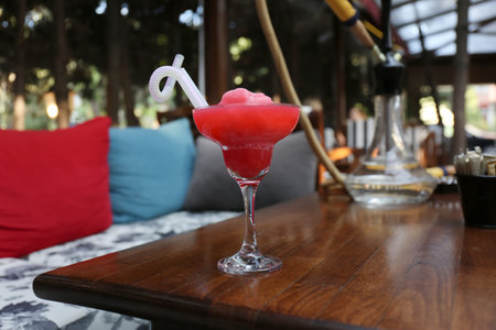 Glass with delicious cocktail on table indoors