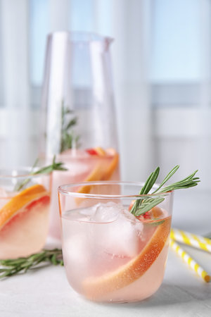 Refreshing grapefruit cocktail with rosemary on tableの写真素材