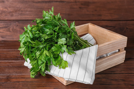 Crate with fresh green parsley on wooden tableの写真素材