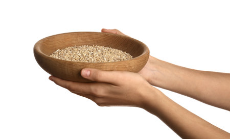 Poor woman holding bowl with grains on white background, closeupの写真素材