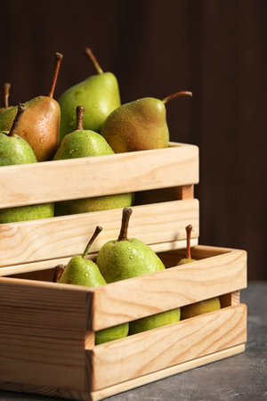 Wooden crates with ripe pears on tableの写真素材