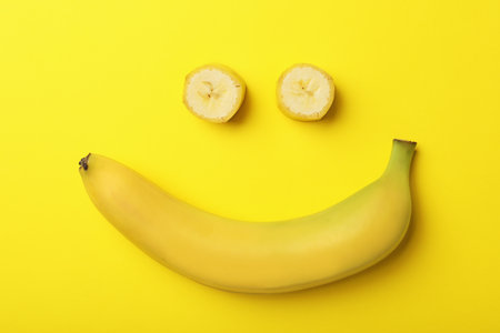 Funny flat lay composition with bananas on color backgroundの写真素材