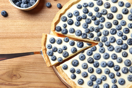 Flat lay composition with tasty blueberry cake on wooden tableの写真素材