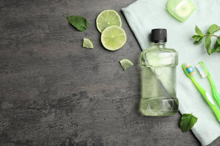 Flat lay composition with mouthwash, toothbrushes and space for text on dark background. Teeth hygieneの写真素材