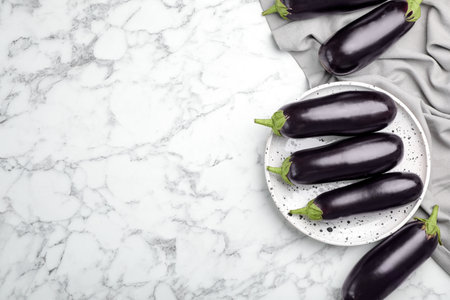 Raw ripe eggplants on marble background, top viewの写真素材