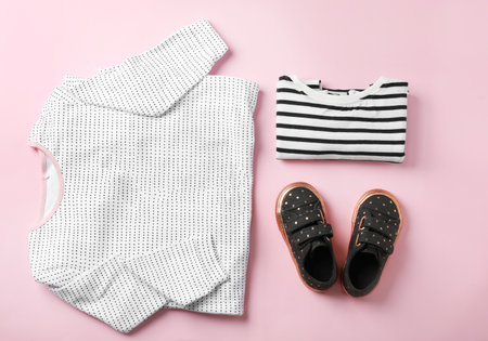 Flat lay composition with cute child clothes and shoes on color backgroundの写真素材