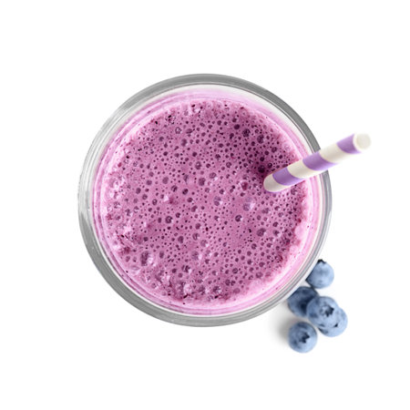 Tasty blueberry smoothie in glass on white background, top viewの写真素材