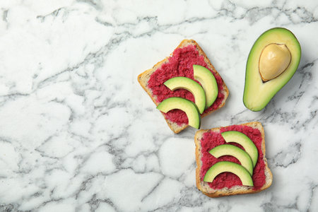 Flat lay composition with crispy toasts and avocado on marble tableの写真素材