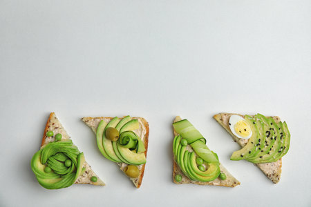 Flat lay composition with crisp avocado toasts on white backgroundの写真素材