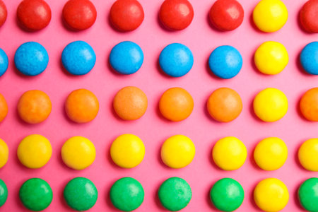Tasty glazed candies on color background, top view