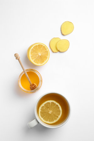 Composition with lemon tea, honey and ginger on white background, top viewの写真素材