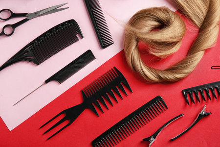 Flat lay composition with hair salon tools on color backgroundの写真素材