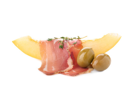 Melon slice with prosciutto and olives on white backgroundの写真素材