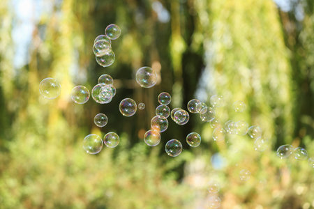 Beautiful translucent soap bubbles outdoors on sunny dayの写真素材