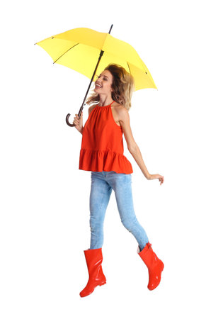 Woman with yellow umbrella on white backgroundの写真素材