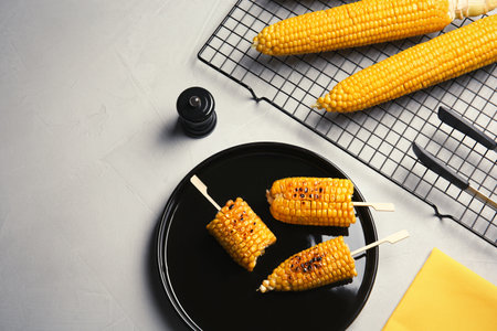 Flat lay composition with tasty corn cobs on light backgroundの写真素材