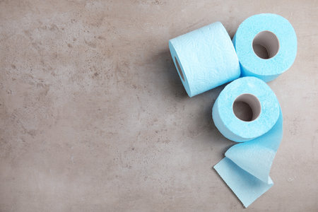 Toilet paper rolls on gray background, top view. Space for textの写真素材