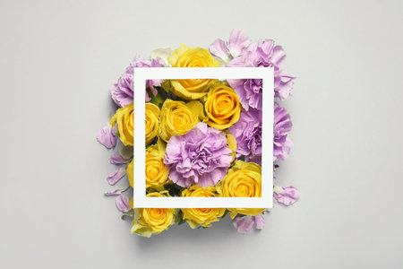 Flat lay composition with beautiful blooming flowers on gray backgroundの写真素材