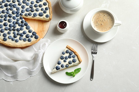 Flat lay composition with piece of tasty blueberry cake on gray tableの写真素材