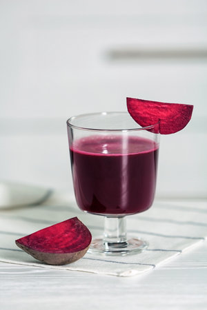 Glass of tasty beet smoothie on tableの写真素材