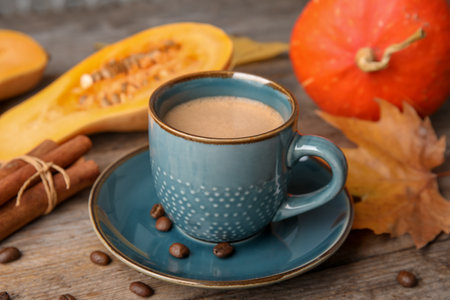 Cup with tasty pumpkin spice latte on wooden tableの写真素材