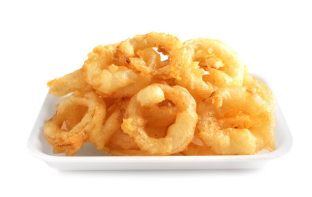 Plate with delicious golden breaded and deep fried crispy onion rings on white backgroundの写真素材