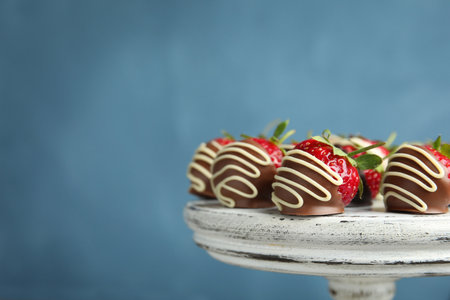 Dessert stand with chocolate covered strawberries on color background, closeupの写真素材