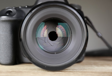 Female photographer holding professional camera on table, closeupの写真素材