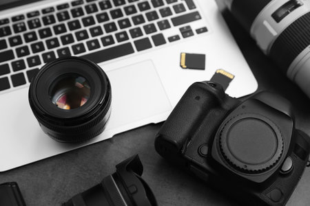 Professional photographer equipment and laptop on tableの写真素材