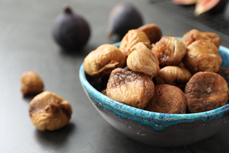 Bowl with delicious dried figs on gray table, closeup. Organic snackの写真素材