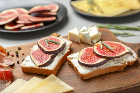 Sandwiches with ripe figs and cream cheese on wooden boardの写真素材