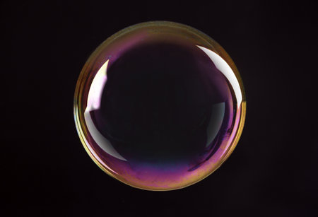 Beautiful translucent soap bubble on dark backgroundの写真素材