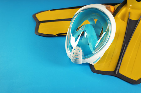 Pair of yellow flippers and diving mask on color background. Space for textの写真素材