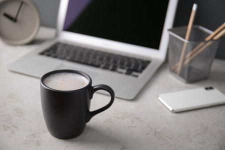 Black cup with coffee on office table. Space for textの写真素材