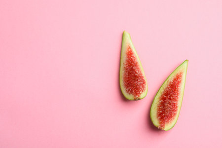 Fresh ripe fig slices on color background, top view. Space for textの写真素材