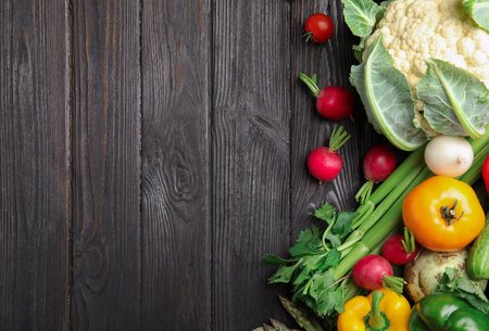 Flat lay composition with assortment of fresh vegetables on wooden table. Space for textの写真素材