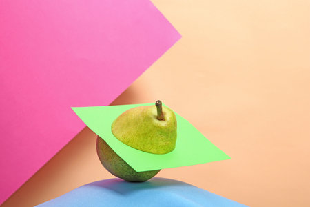 Creative composition with fresh ripe pear against color backgroundの写真素材