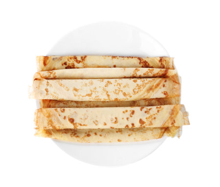 Tasty thin pancake rolls on plate against white background, top viewの写真素材