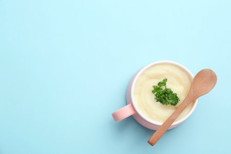 Bowl with tasty mashed potatoes and space for text on color background, top viewの写真素材