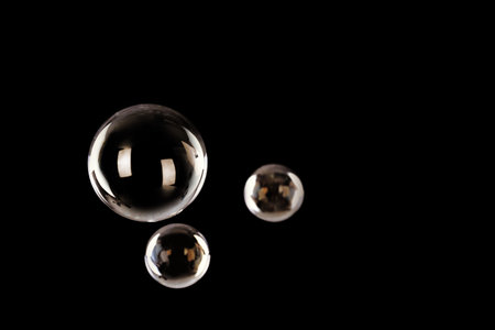 Beautiful translucent soap bubbles on dark background. Space for textの写真素材