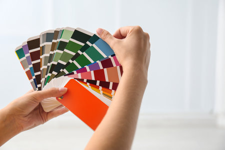 Female interior designer with palette color samples indoors, closeupの写真素材